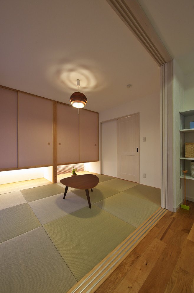 Photo of an asian enclosed family room in Other with white walls, tatami floors, no fireplace and green floor.