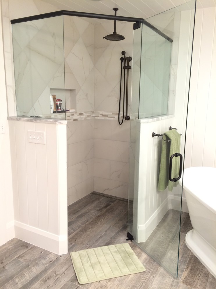 Mid-sized beach style master bathroom in Tampa with shaker cabinets, white cabinets, a freestanding tub, a curbless shower, a two-piece toilet, white tile, porcelain tile, white walls, porcelain floors, a drop-in sink and wood benchtops.