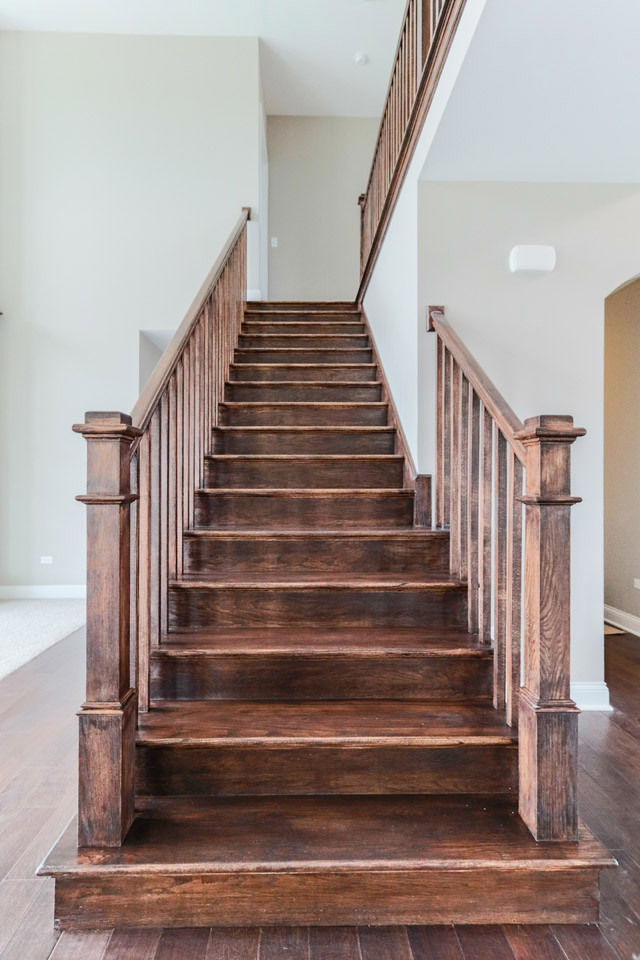 Inspiration for a large arts and crafts wood straight staircase in Chicago with wood risers.