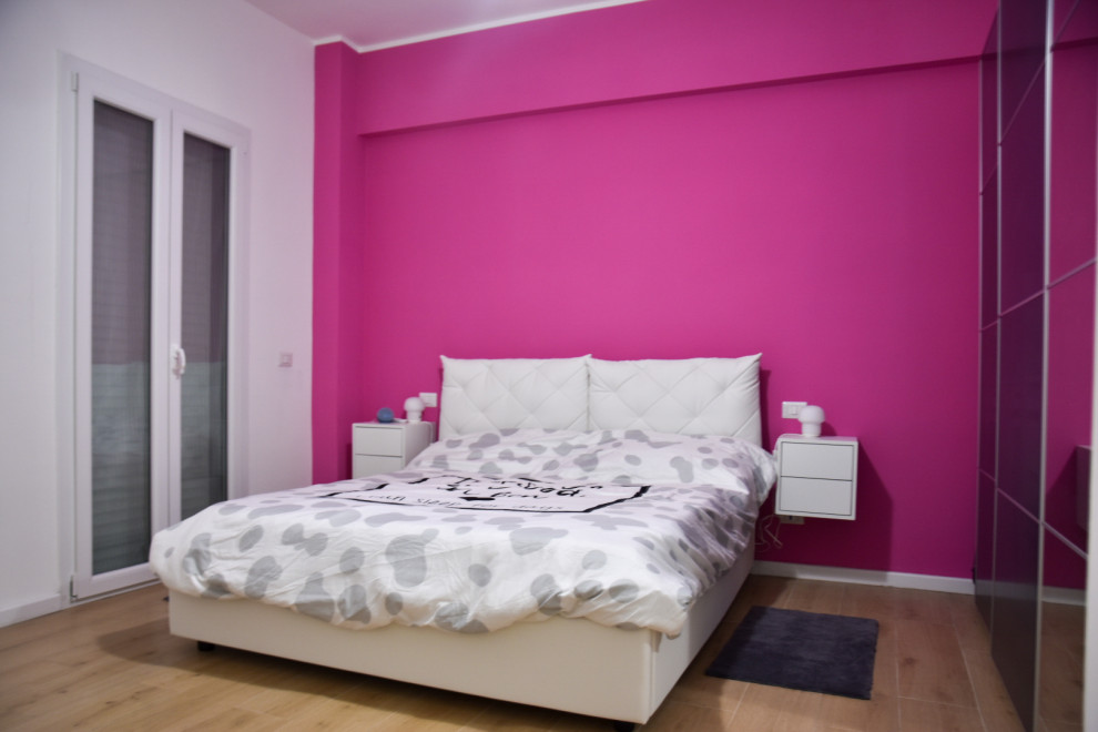 Design ideas for a modern master bedroom with pink walls and porcelain floors.