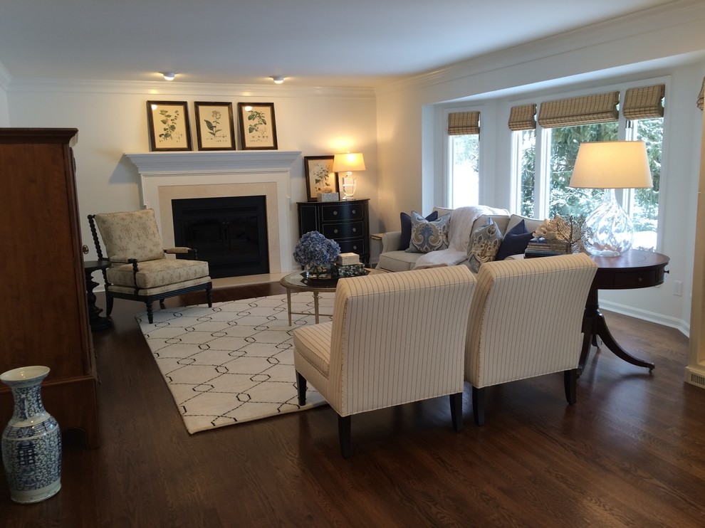Inspiration for a large transitional open concept family room in Cincinnati with dark hardwood floors, white walls, a standard fireplace and a concealed tv.