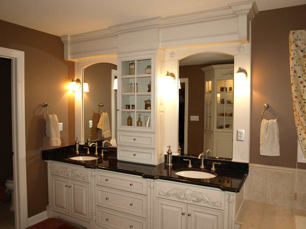 Inspiration for a mid-sized traditional master bathroom in New York with an undermount sink, raised-panel cabinets, white cabinets, beige tile, ceramic tile, brown walls and porcelain floors.