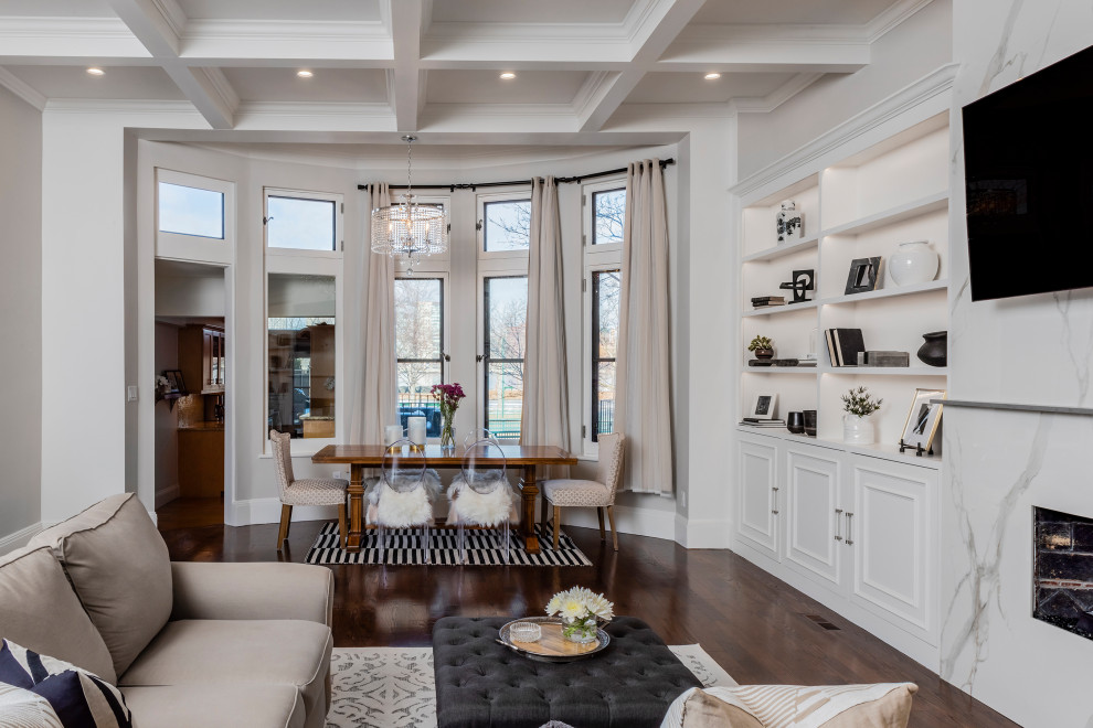 This is an example of a mid-sized transitional open plan dining in Boston with white walls, a tile fireplace surround, brown floor and coffered.