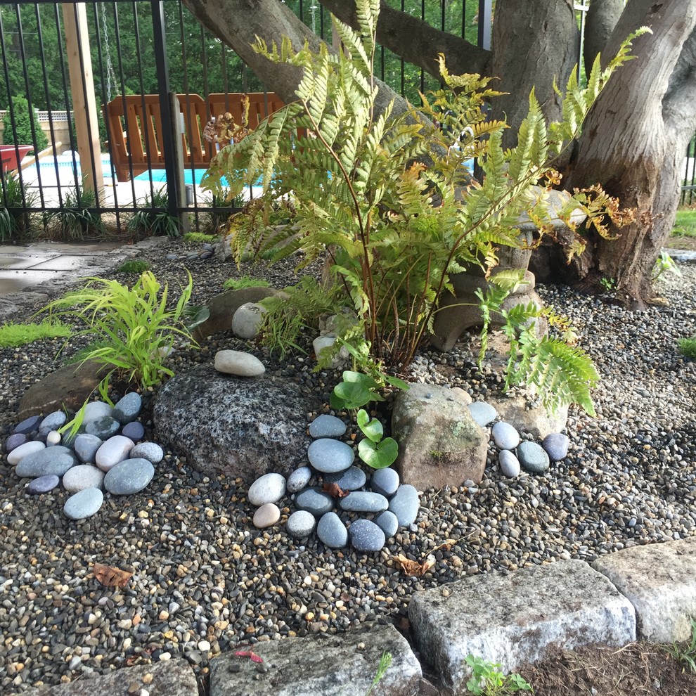 Inspiration for a mid-sized asian backyard partial sun garden for summer in Providence with a water feature and gravel.