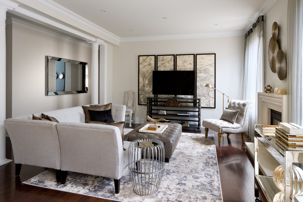 Example of a transitional open concept dark wood floor living room design in Toronto with beige walls and a standard fireplace