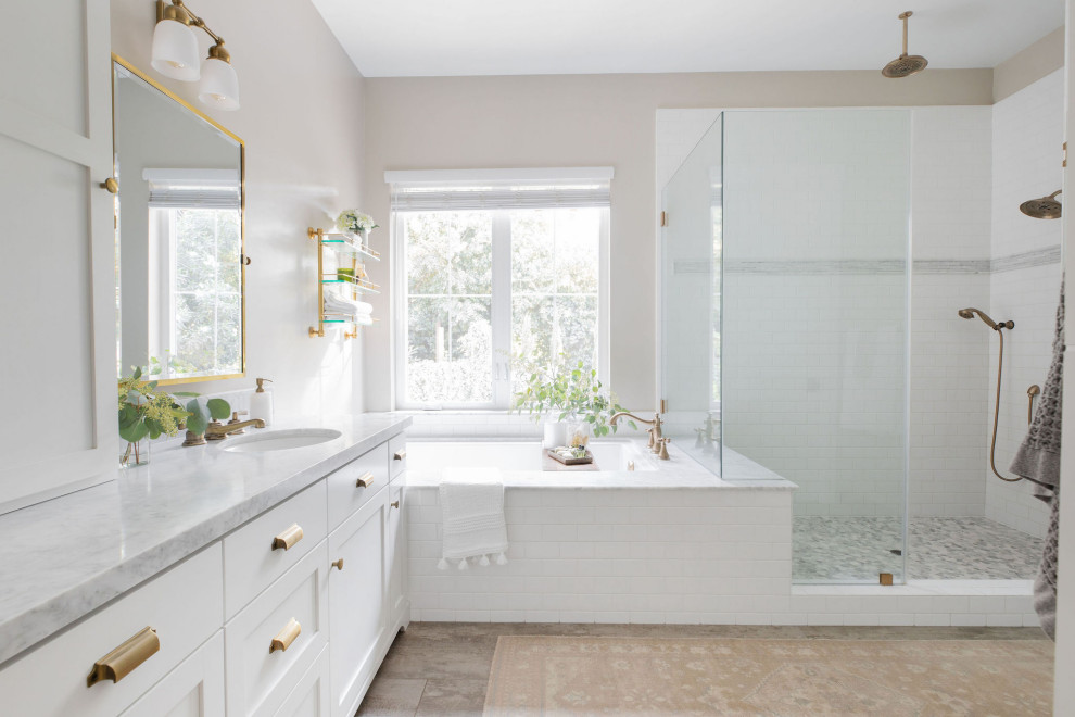 Transitional master bathroom in Sacramento with shaker cabinets, white cabinets, an undermount tub, an alcove shower, subway tile, beige walls, an undermount sink, marble benchtops, beige floor, a hinged shower door, grey benchtops, a double vanity and a built-in vanity.