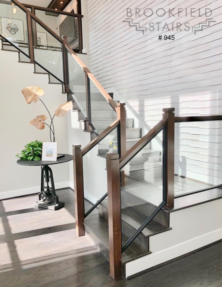 Large modern wood u-shaped staircase in Seattle with wood risers and mixed railing.