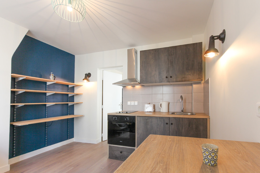 Design ideas for a small contemporary single-wall eat-in kitchen in Paris with medium wood cabinets.