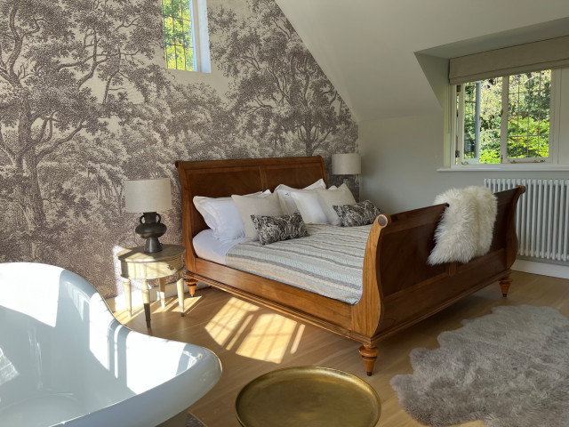 Master bedroom with bath in a forest setting farmhouse-bedroom