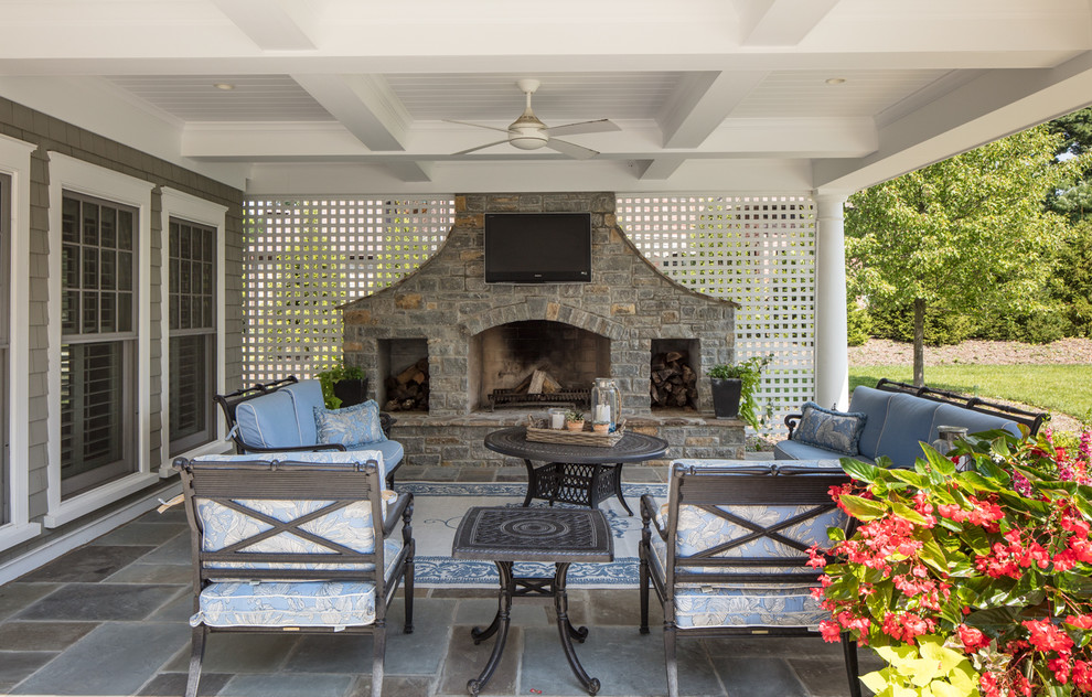 This is an example of a traditional backyard patio in Cincinnati with with fireplace.