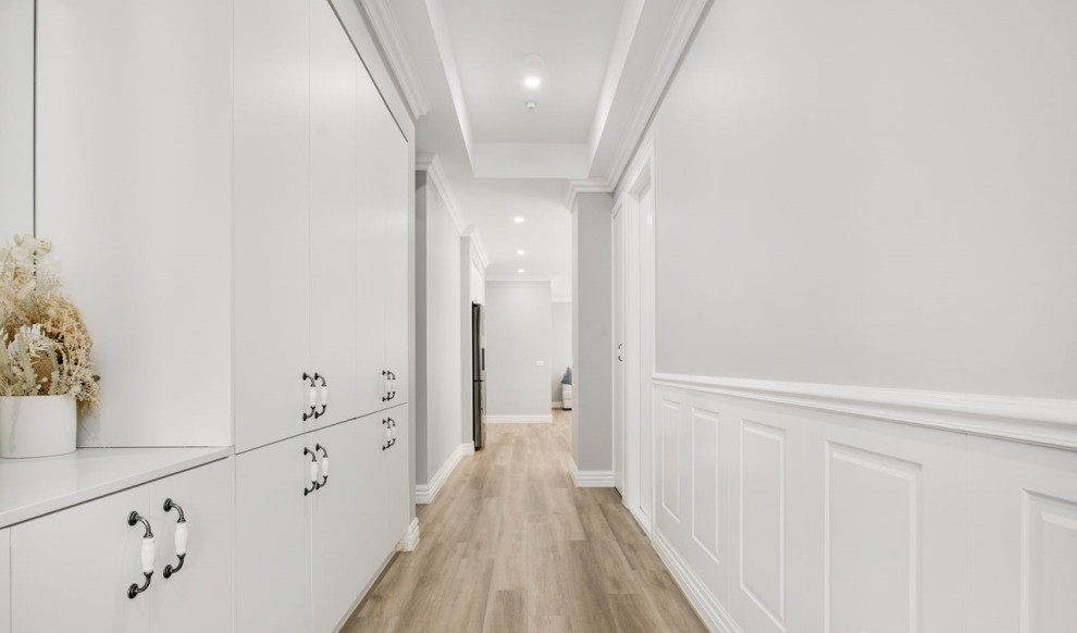 Design ideas for a victorian hallway in Melbourne with decorative wall panelling and bamboo floors.