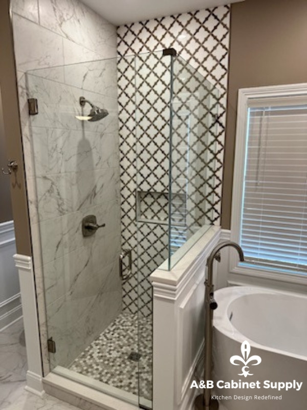 Example of a mid-sized transitional master cement tile floor, multicolored floor and double-sink freestanding bathtub design with raised-panel cabinets, medium tone wood cabinets, beige walls, an undermount sink, quartz countertops, white countertops and a built-in vanity