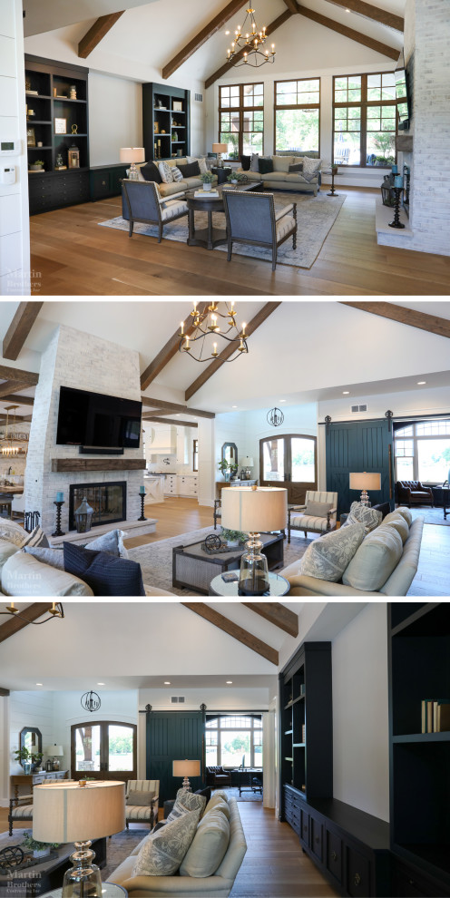 Inspiration for a large country formal open concept living room in Other with white walls, light hardwood floors, a two-sided fireplace, a brick fireplace surround, a wall-mounted tv and vaulted.