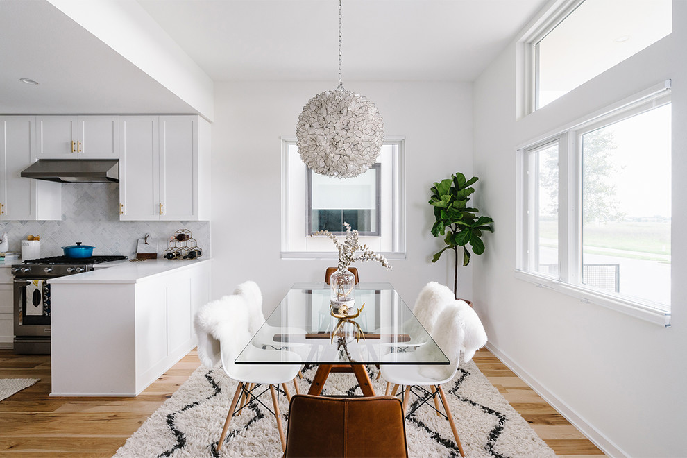 This is an example of a large scandinavian kitchen/dining combo in Austin with white walls, light hardwood floors and no fireplace.