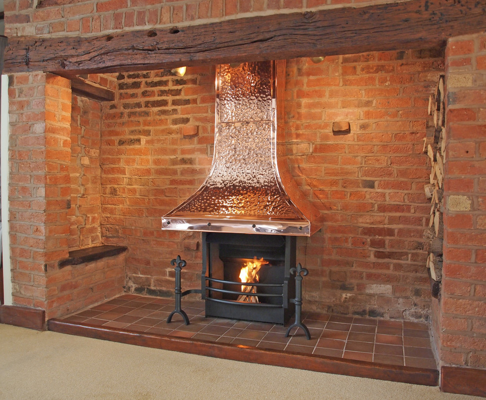 Large classic open plan living room with a reading nook, a standard fireplace and a brick fireplace surround.