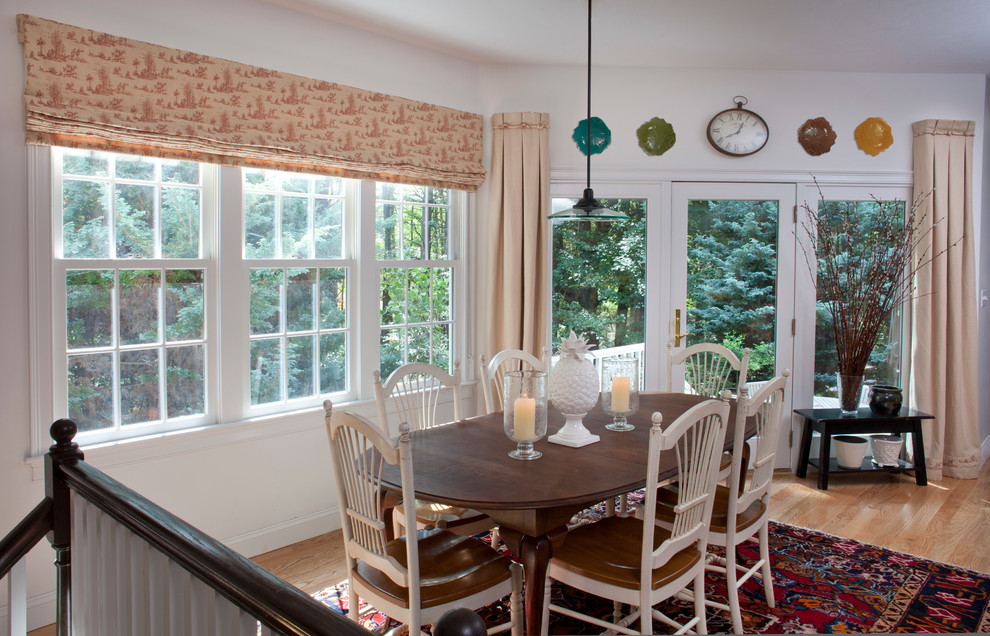 Mid-sized traditional open plan dining in Boston with white walls, light hardwood floors, no fireplace and beige floor.