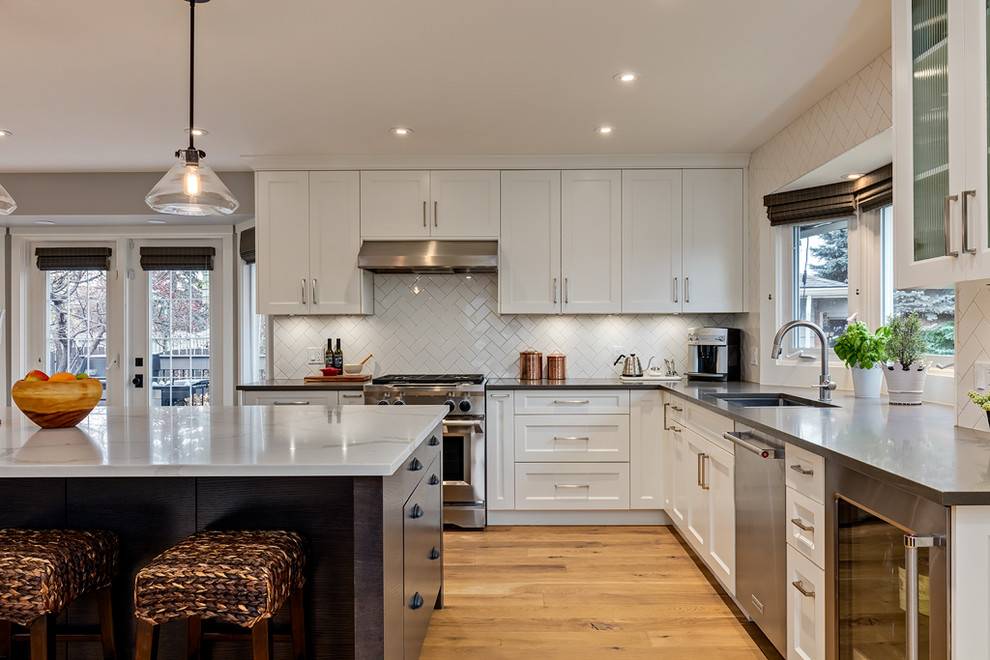 Example of a transitional kitchen design in Calgary