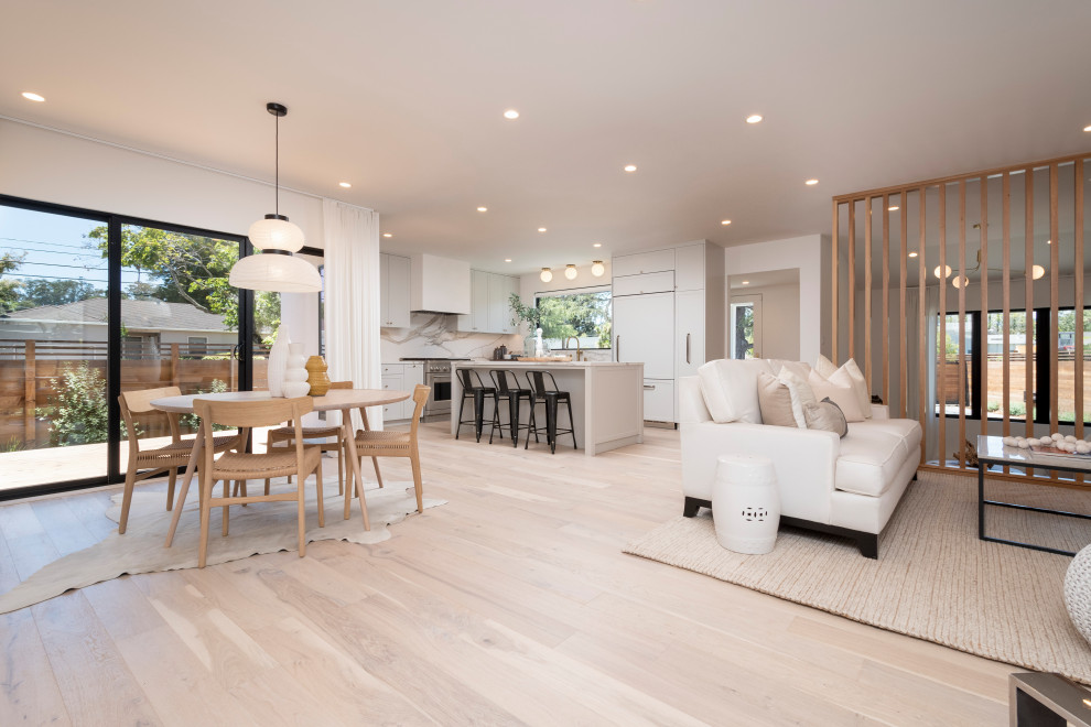 Design ideas for a mid-sized modern open plan dining in San Francisco with white walls and light hardwood floors.