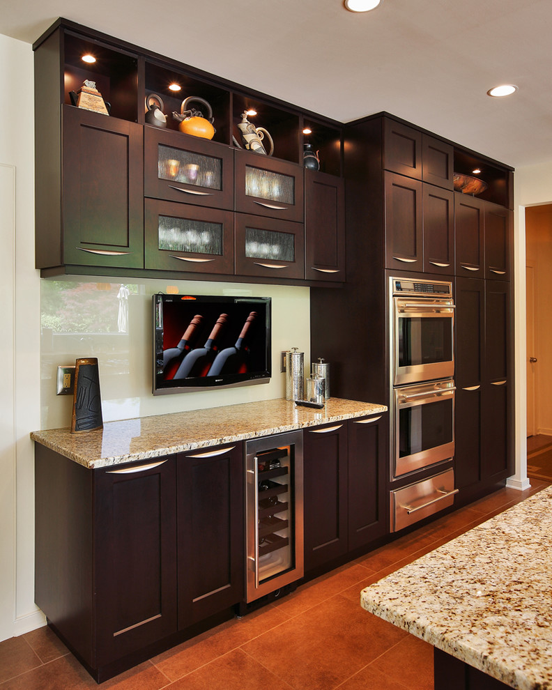 Inspiration for a large transitional u-shaped ceramic tile eat-in kitchen remodel in DC Metro with an undermount sink, shaker cabinets, dark wood cabinets, granite countertops, yellow backsplash, glass sheet backsplash, stainless steel appliances and an island