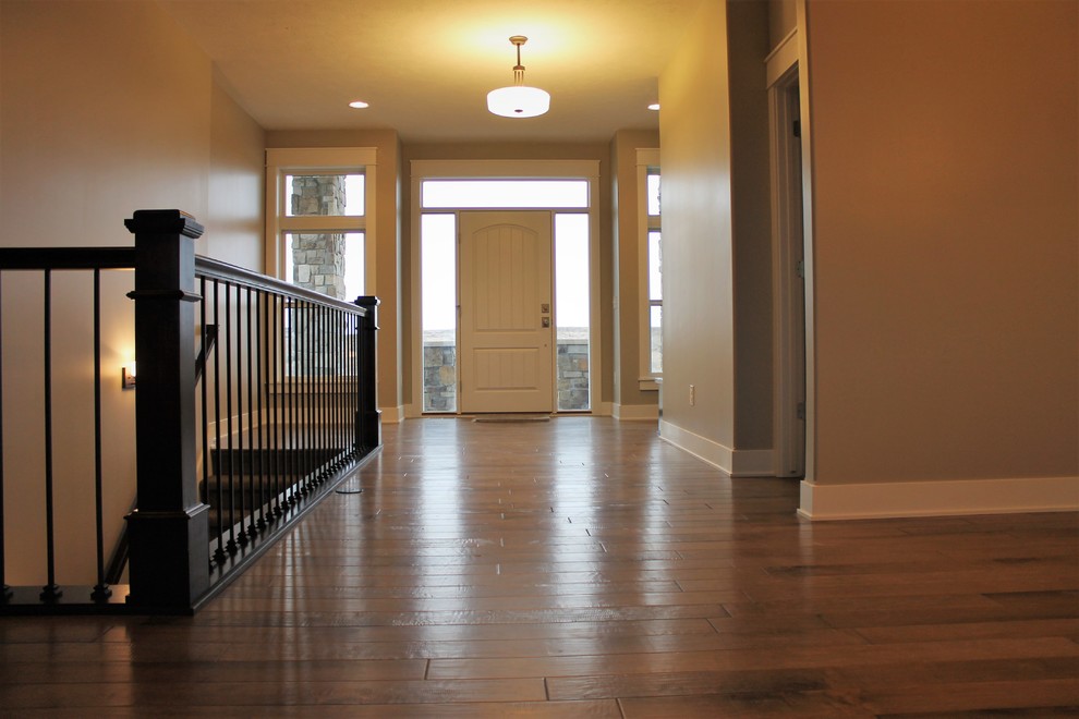 Inspiration for a mid-sized transitional medium tone wood floor foyer remodel