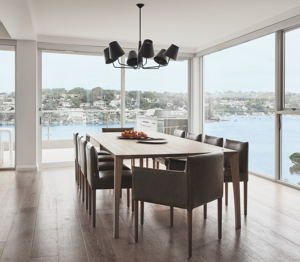 Photo of a large contemporary kitchen/dining combo in Sydney with light hardwood floors.
