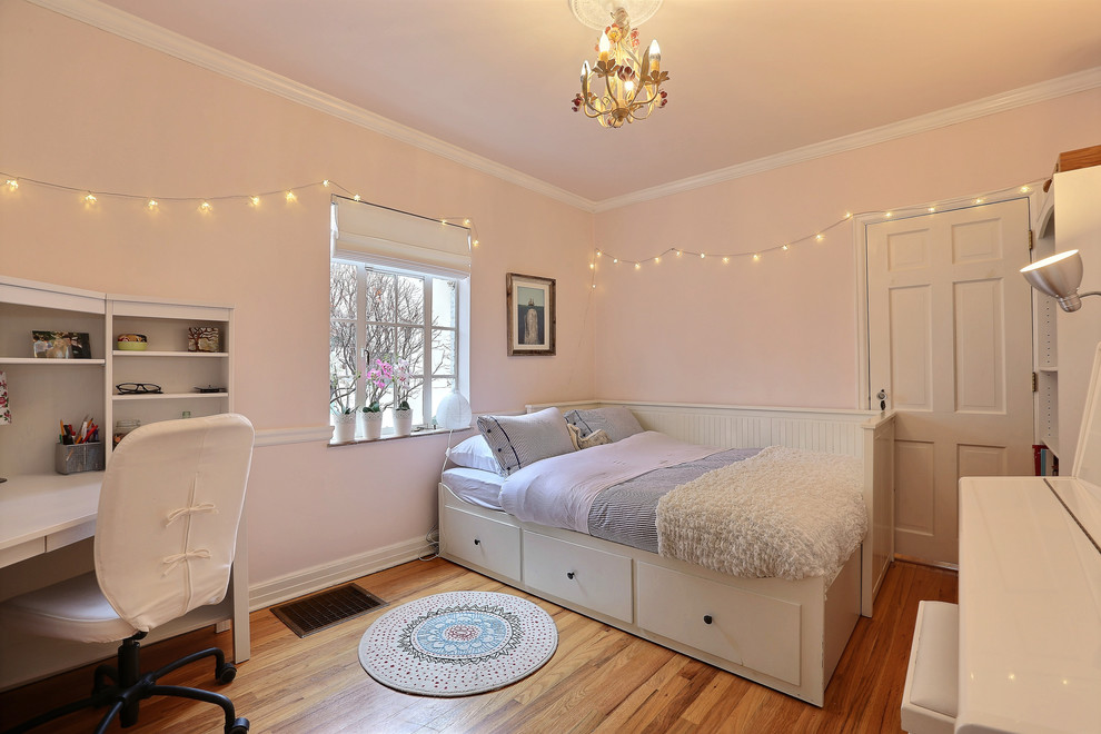 Design ideas for a transitional kids' bedroom for kids 4-10 years old and girls in Denver with pink walls and medium hardwood floors.