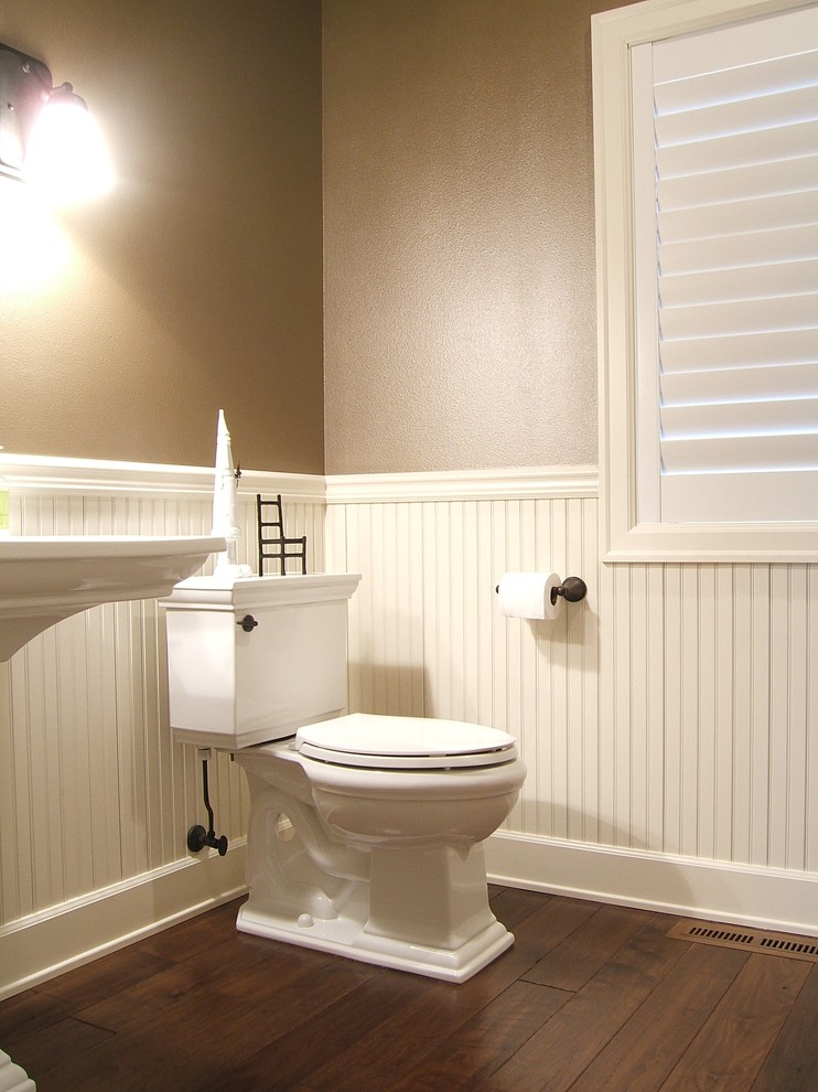 Traditional powder room in Portland with brown walls and dark hardwood floors.