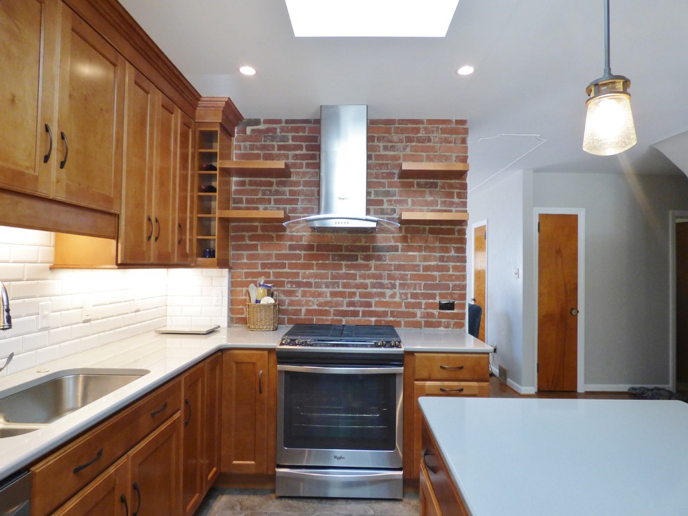 Inspiration for a transitional l-shaped porcelain tile eat-in kitchen remodel with an undermount sink, recessed-panel cabinets, medium tone wood cabinets, quartz countertops, white backsplash, subway tile backsplash, stainless steel appliances and an island