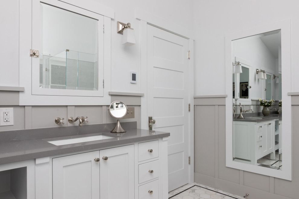 Inspiration for a large arts and crafts master bathroom in Los Angeles with shaker cabinets, white cabinets, white tile, ceramic tile, white walls, marble floors, an undermount sink, engineered quartz benchtops, white floor, grey benchtops, a double vanity, a built-in vanity, vaulted and decorative wall panelling.