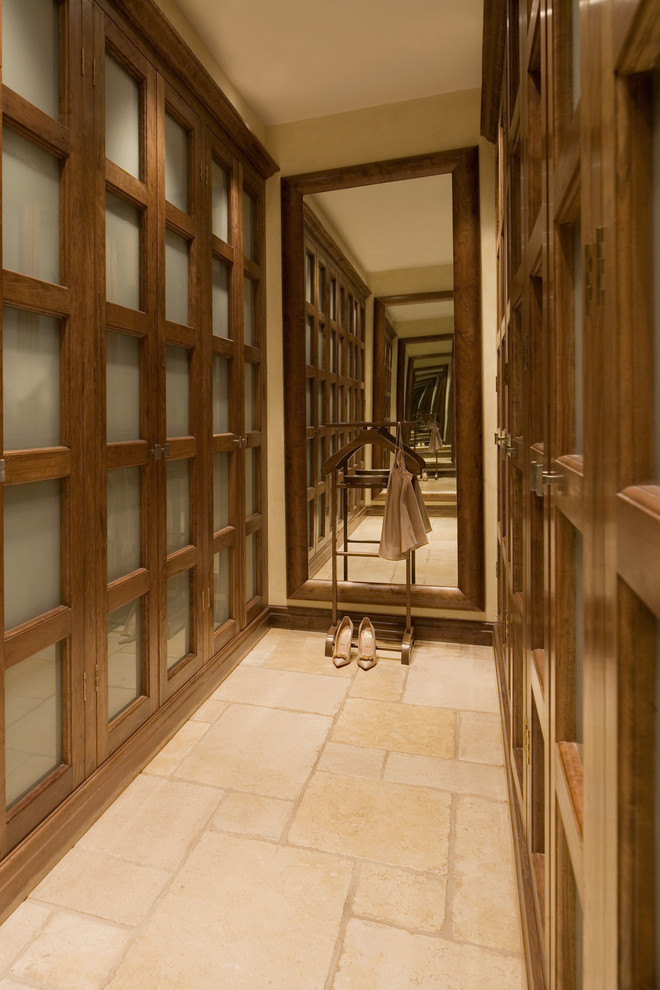 Inspiration for a contemporary walk-in wardrobe in London with travertine floors.