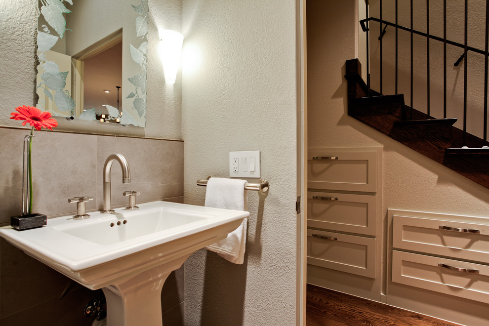 Photo of a mid-sized traditional powder room in Dallas with beige tile, grey walls, a pedestal sink and ceramic tile.