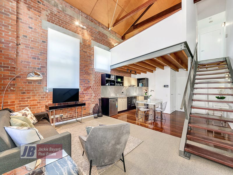 This is an example of a medium sized urban mezzanine living room in Brisbane.