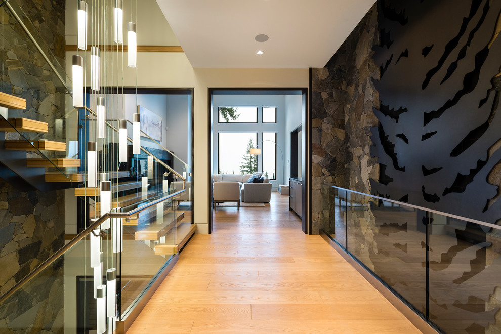 This is an example of an expansive transitional hallway in Vancouver with white walls, light hardwood floors and beige floor.