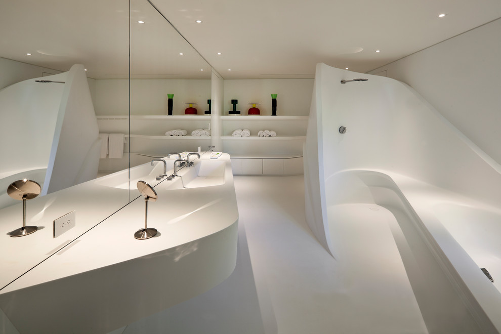This is an example of a contemporary master bathroom in Miami with white cabinets, a drop-in tub, an open shower, white walls, an integrated sink, white floor, an open shower and white benchtops.