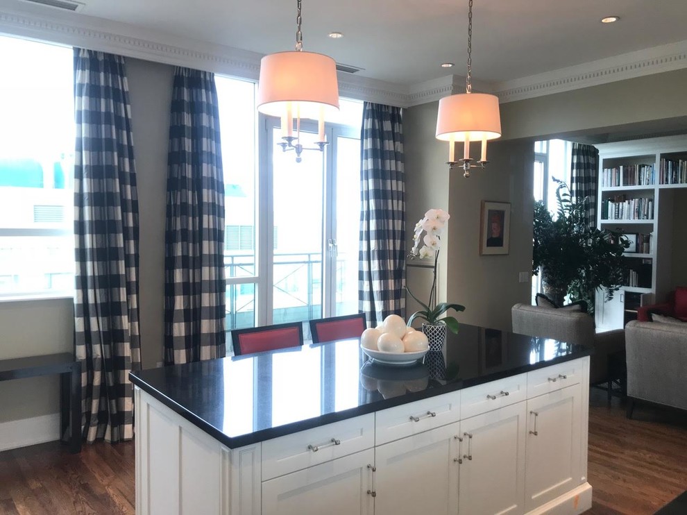 Open concept kitchen - transitional single-wall dark wood floor and brown floor open concept kitchen idea in Toronto with shaker cabinets, white cabinets, solid surface countertops, mirror backsplash, paneled appliances and an island