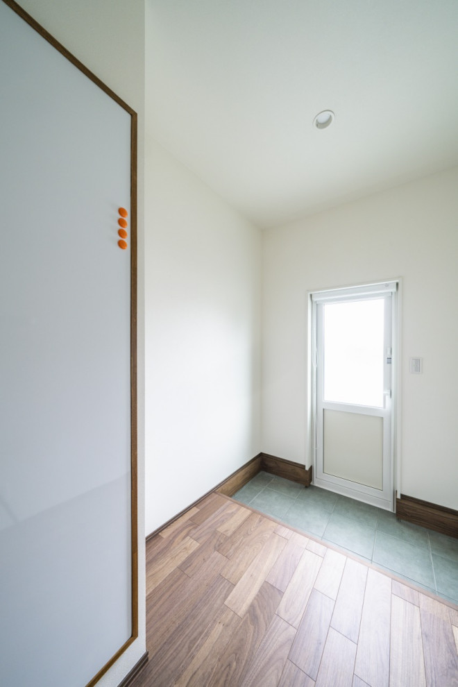 Modelo de sala de estar blanca minimalista de tamaño medio con paredes blancas, suelo de madera oscura, suelo marrón, papel pintado y papel pintado