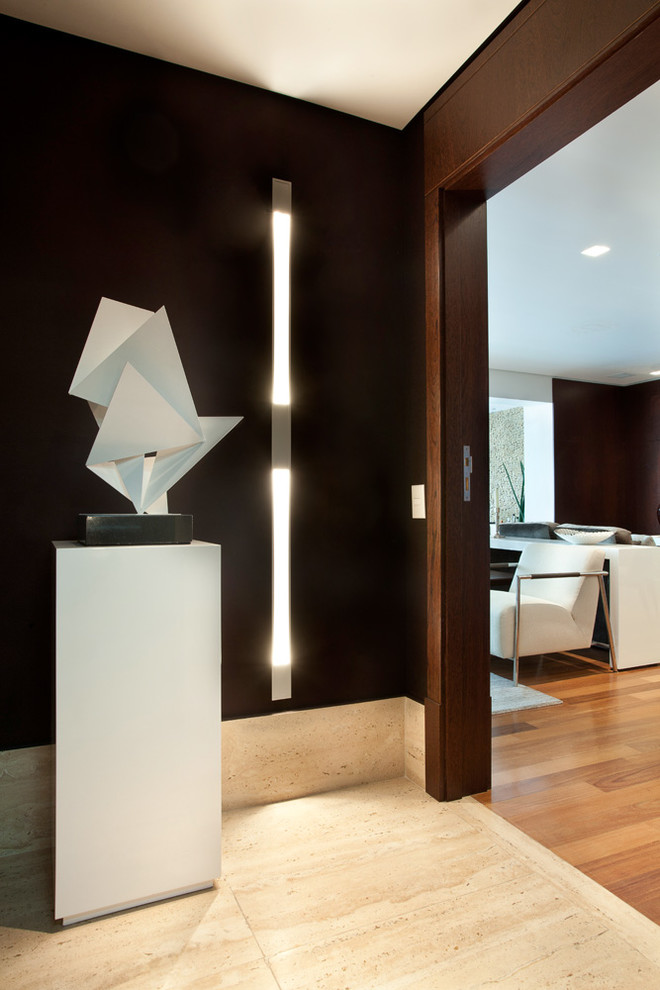 This is an example of a small contemporary hallway in Other with brown walls and marble floors.