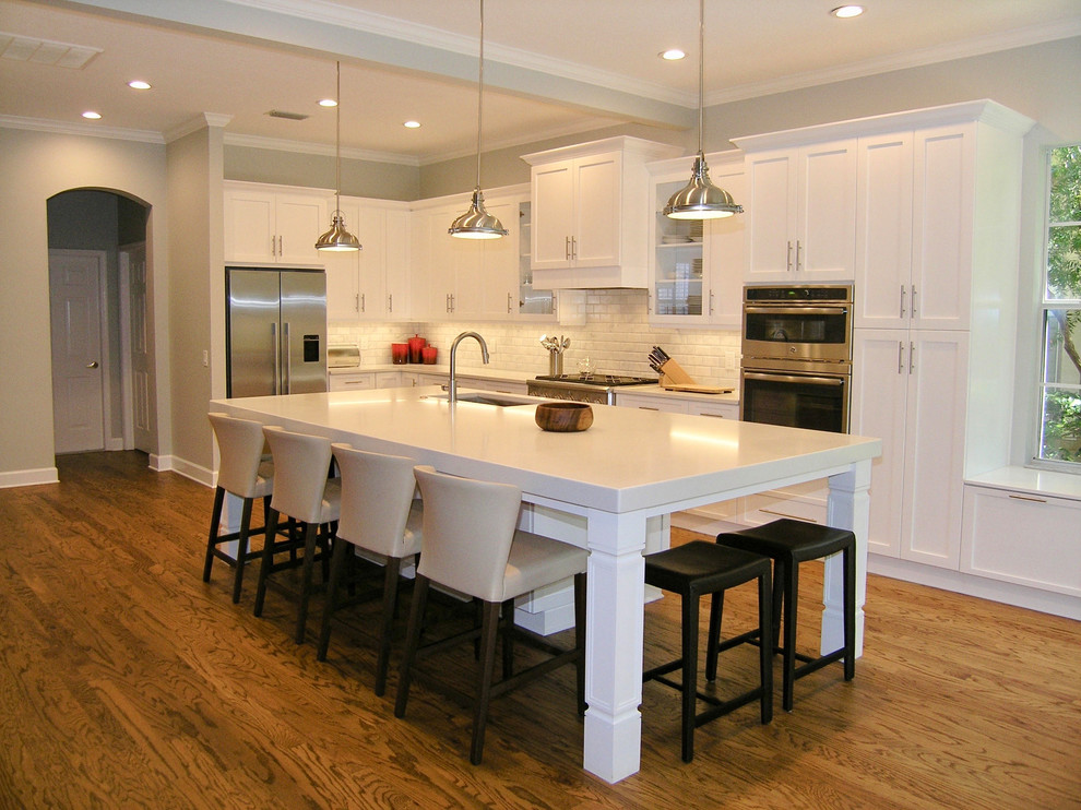 Photo of a traditional kitchen in Tampa with medium hardwood floors, with island and yellow floor.