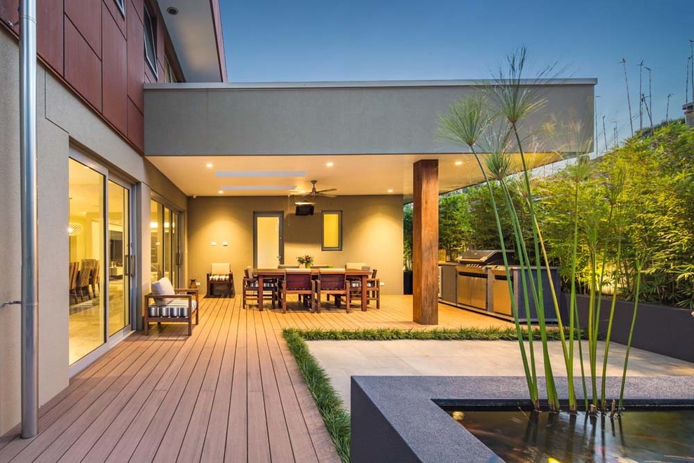 Inspiration for a large contemporary side yard deck in Sydney with an outdoor kitchen and a roof extension.