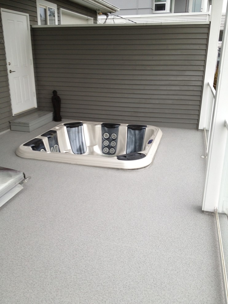 Inspiration for a mid-sized transitional backyard deck remodel in Vancouver with a roof extension