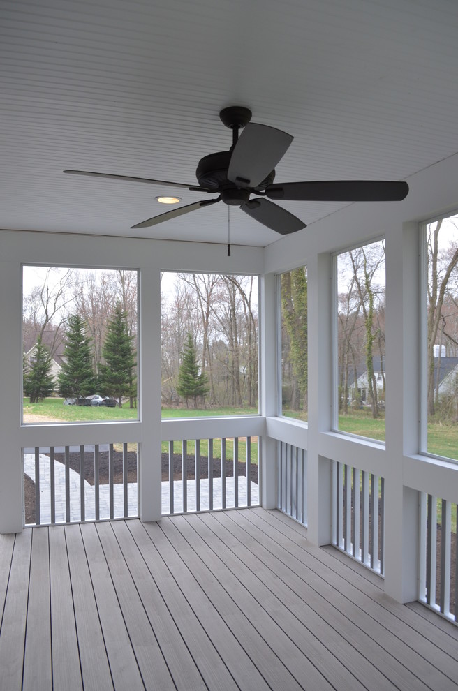 This is an example of a mid-sized traditional backyard verandah in Wilmington with decking and a roof extension.