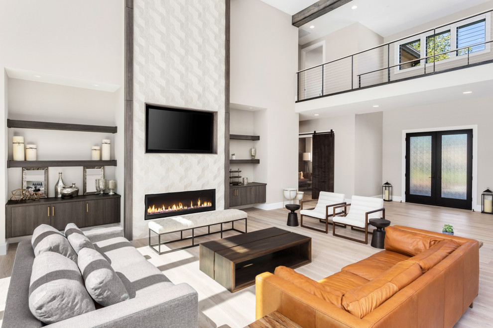Design ideas for a contemporary open plan living room in Miami with white walls, light hardwood flooring, a ribbon fireplace and a tiled fireplace surround.