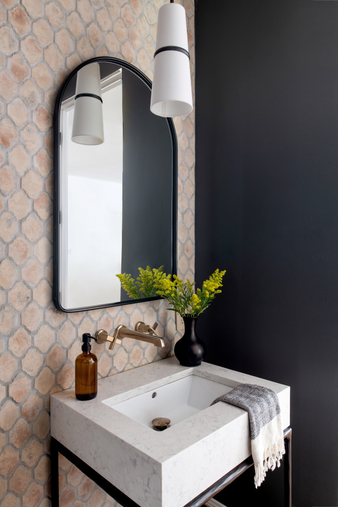Inspiration for a small mediterranean beige tile and terra-cotta tile light wood floor and beige floor powder room remodel in Los Angeles with white cabinets, a one-piece toilet, black walls, a console sink, marble countertops, gray countertops and a freestanding vanity