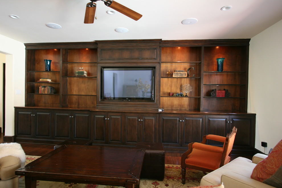 Photo of a large traditional open concept home theatre in Los Angeles with beige walls, marble floors and a built-in media wall.