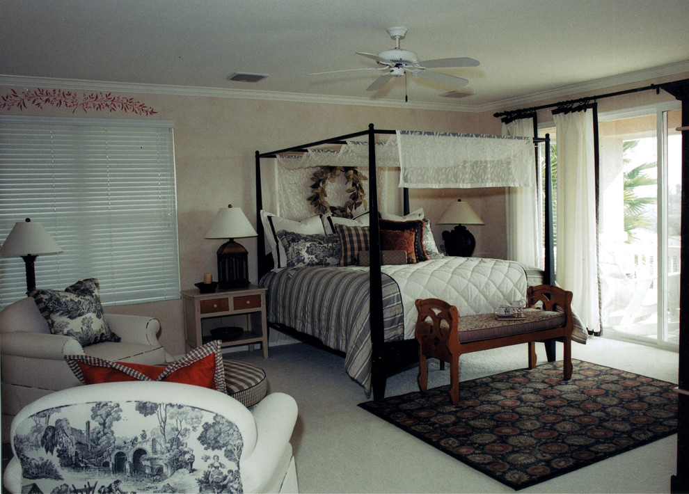 Photo of a large country master bedroom in San Diego with yellow walls and carpet.