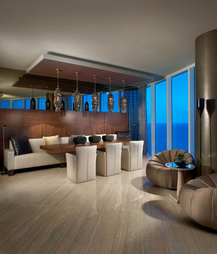 This is an example of a contemporary open plan dining in Miami with marble floors.