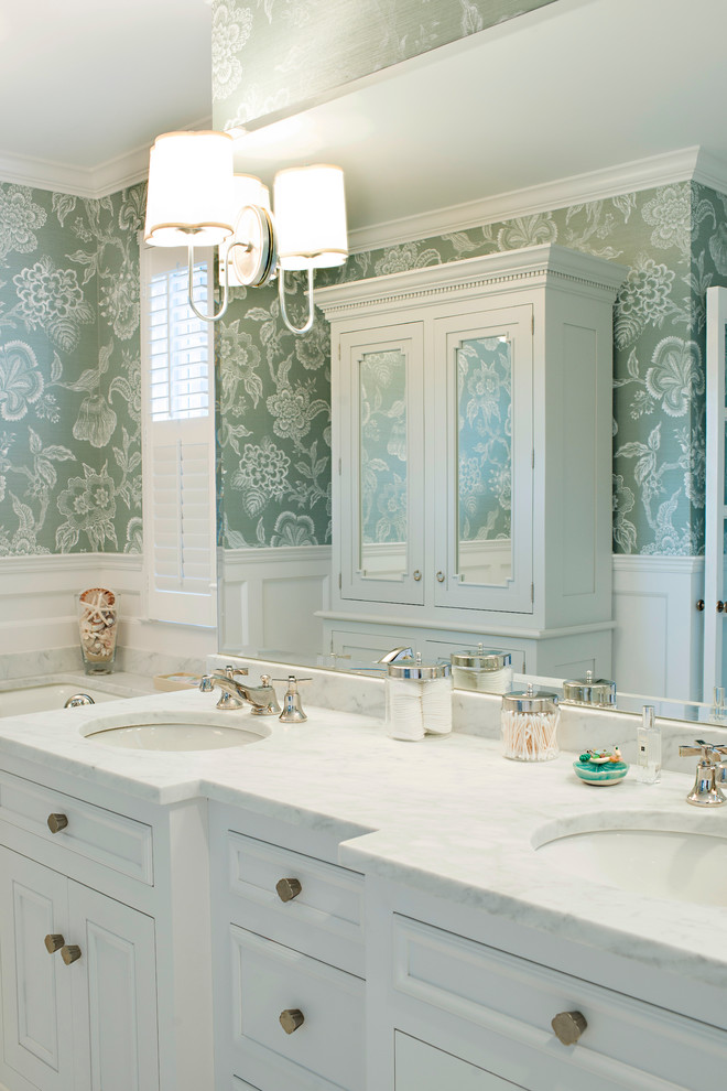 Traditional bathroom in Baltimore with an undermount sink, white cabinets and green walls.