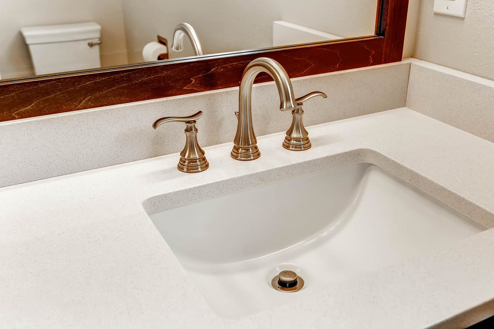 Small transitional master cement tile ceramic tile doorless shower photo in Denver with shaker cabinets, dark wood cabinets, a one-piece toilet, beige walls, an undermount sink and quartz countertops