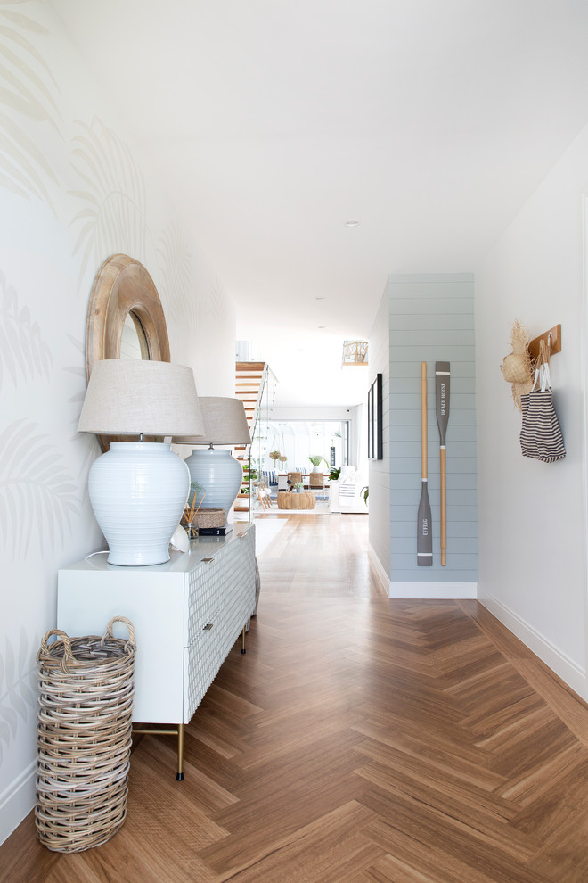 Design ideas for a large beach style foyer in Gold Coast - Tweed with white walls, vinyl floors, a single front door, a black front door and brown floor.