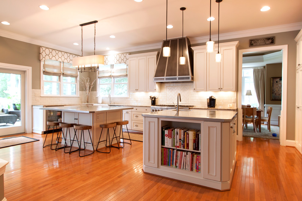Example of a large transitional medium tone wood floor kitchen design in DC Metro with an undermount sink, white cabinets, granite countertops, white backsplash, ceramic backsplash and stainless steel appliances